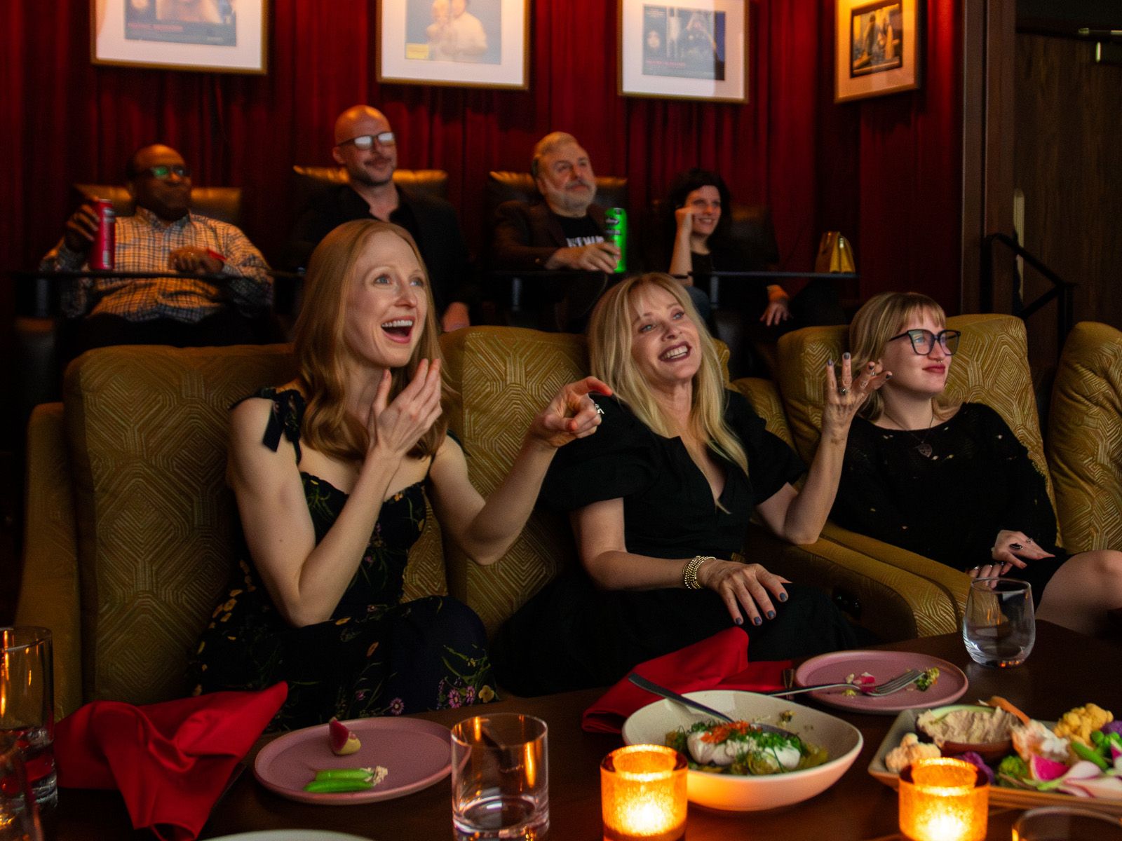 Guests enjoying a private movie screening and laughing together in a Metro Private Cinema suite